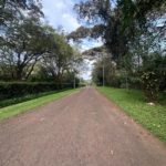 Rich1 Acre Land for Sale in Karen in a gated community, with a driveway and red soil. Asking Price: 70M. Musilli Homes.