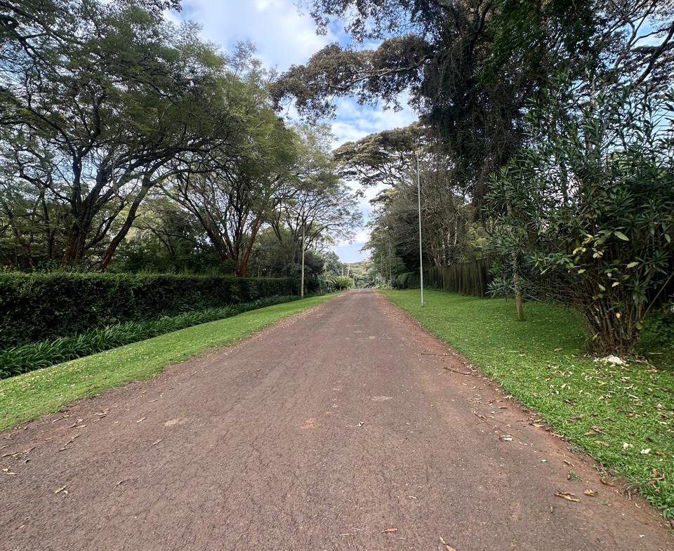 Rich1 Acre Land for Sale in Karen in a gated community, with a driveway and red soil. Asking Price: 70M. Musilli Homes.